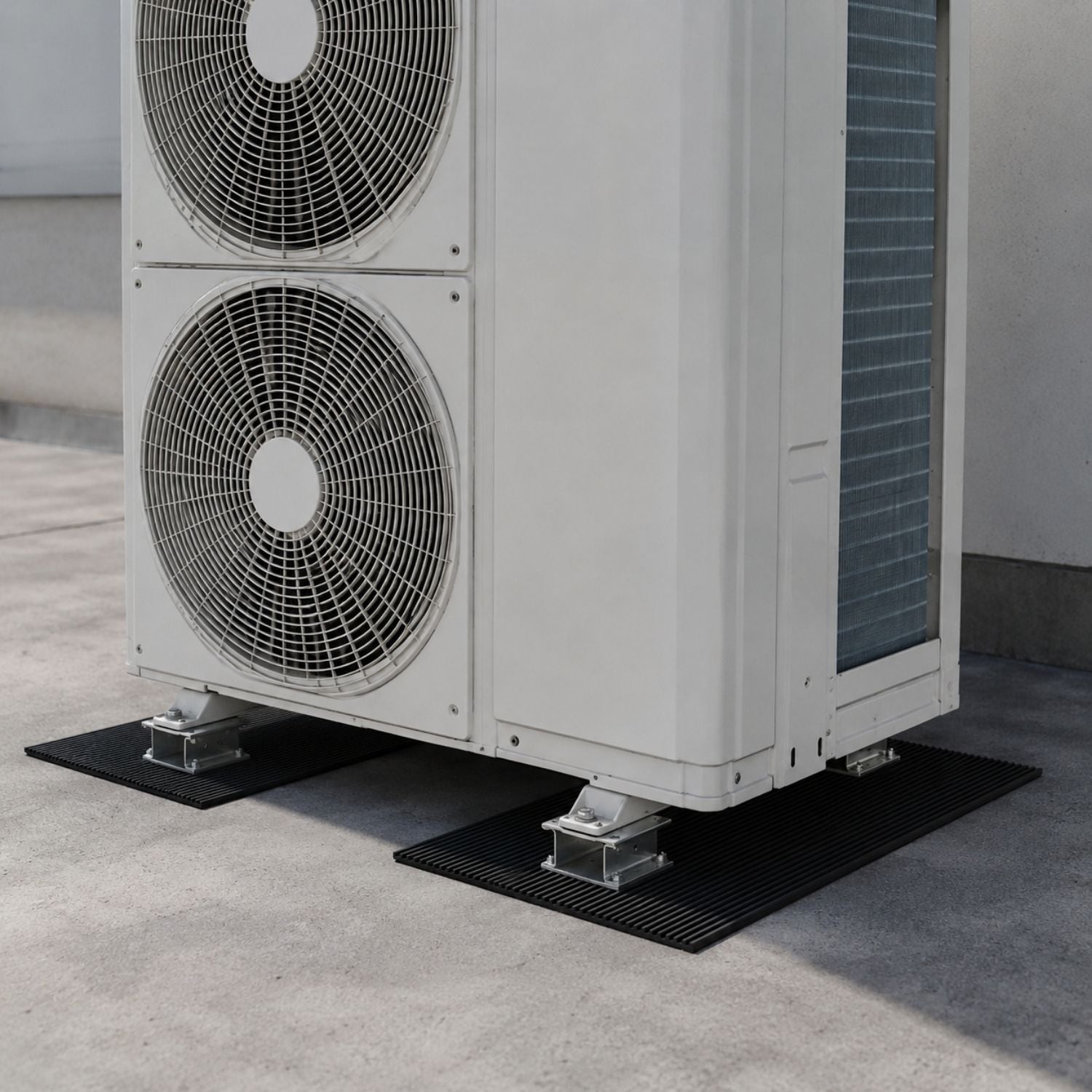 Acrefine single-sided ribbed anti vibration rubber matting installed on a concrete rooftop under a mechanical HVAC condenser unit.