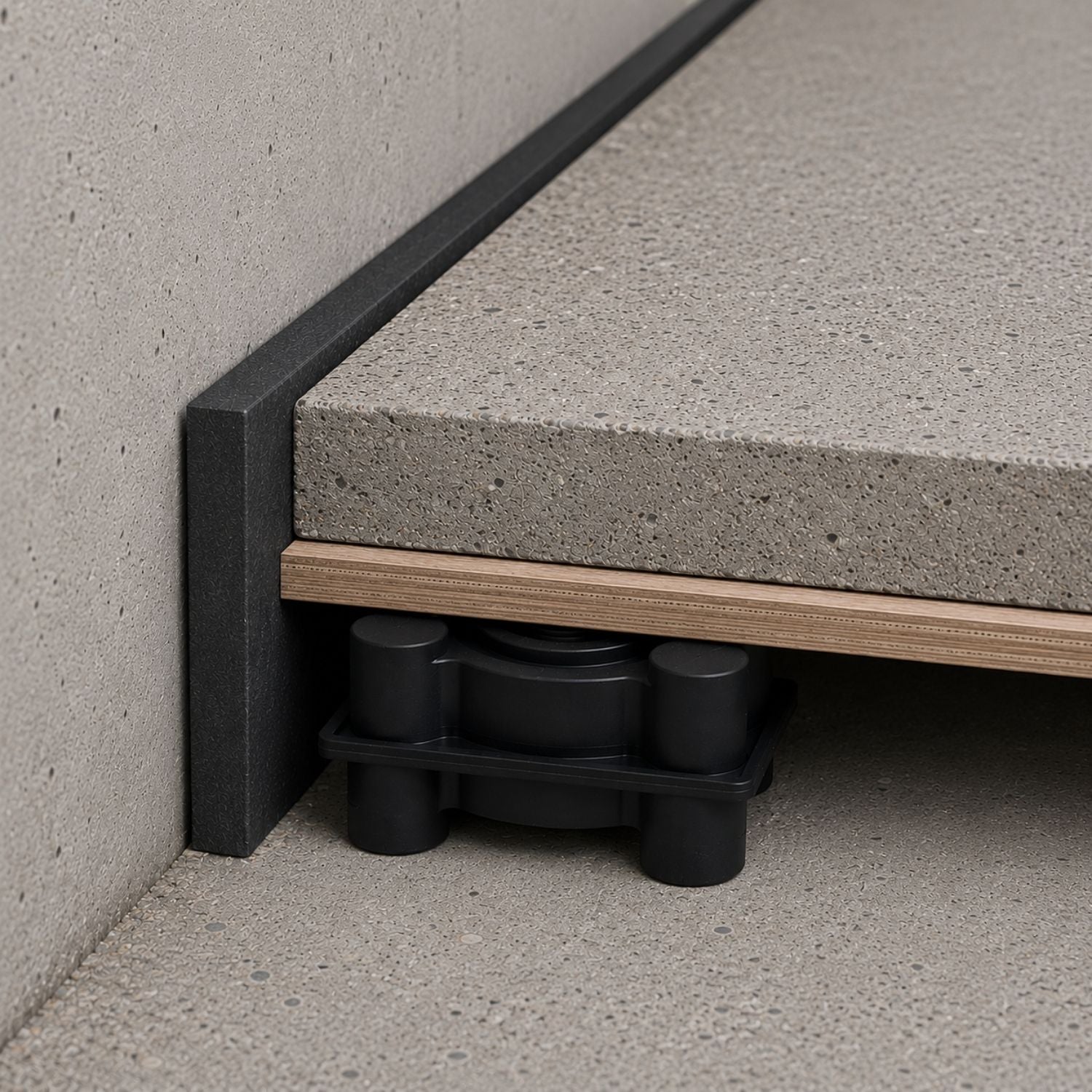 Acrefine floating floor mount installed under concrete screed and perimeter isolation strip for structural noise decoupling.