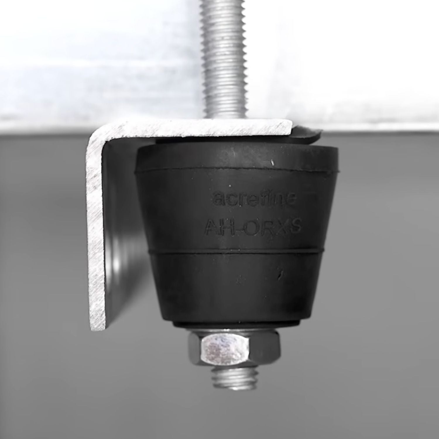 Side view of Acrefine elastomer vibration hanger installed on a suspension bracket for acoustic decoupling.