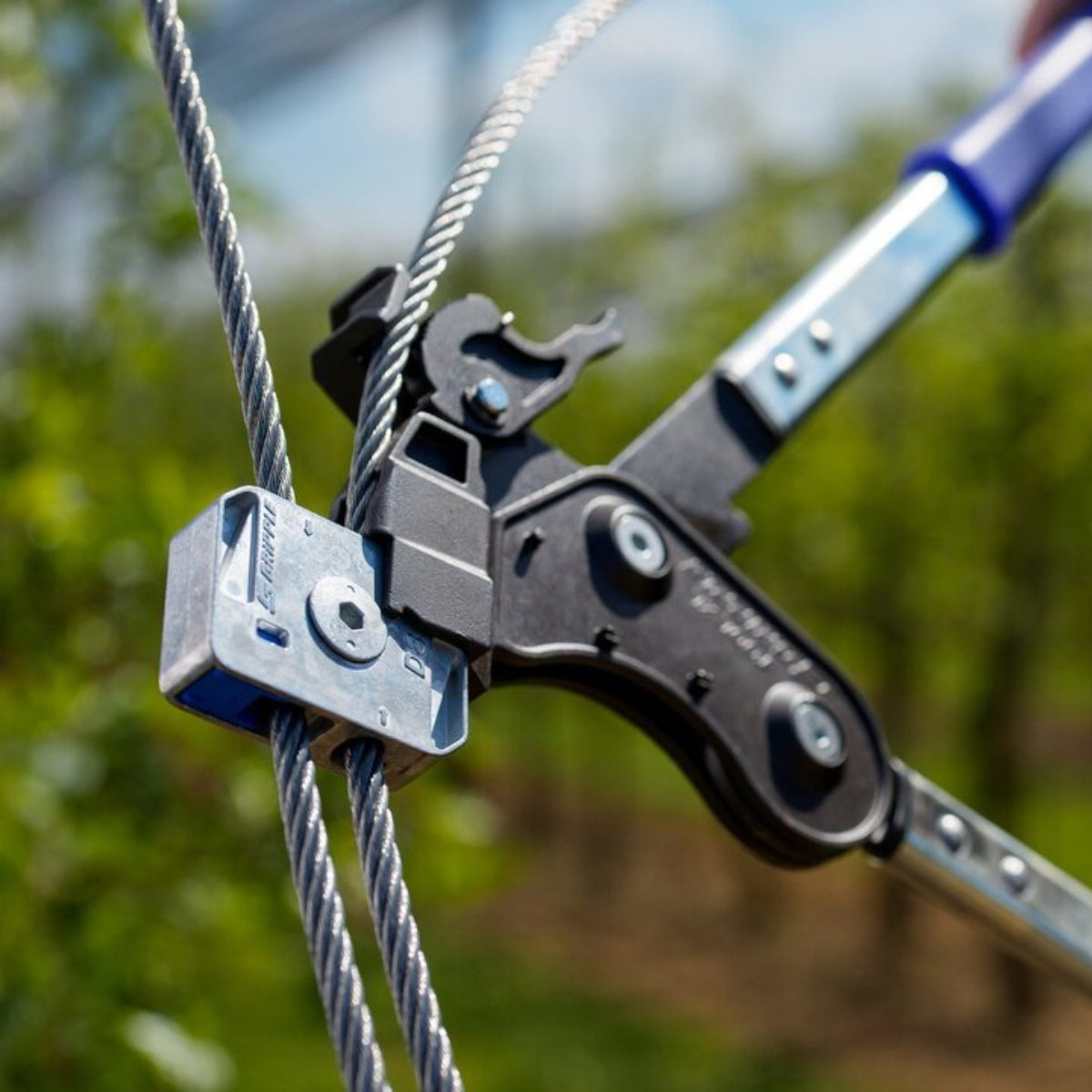 A Gripple Dynamic on a vineyard wire with the Gripple tensioning tool attached.